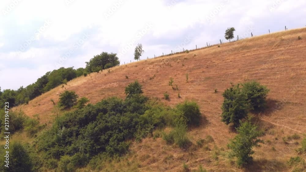Drone shot of dry grass hill Drone shot of dry grass hill