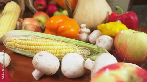 Autumnal Harvest or Thanksgiving, Cornucopia filled with vegetables, vegetables spilled out of the basket on the table. 4k, dolly shot photo