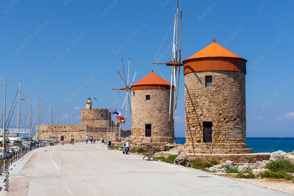 The historic windmills at the Mandraki harbor in Rhodes town. Rhodes Island, Greece The historic windmills at the Mandraki harbor in Rhodes town. Rhodes Island, Greece