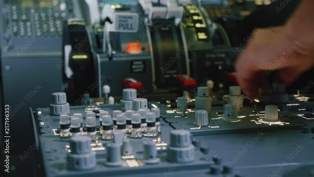 Panel of switches on an aircraft flight deck. Pilot controls the aircraft.