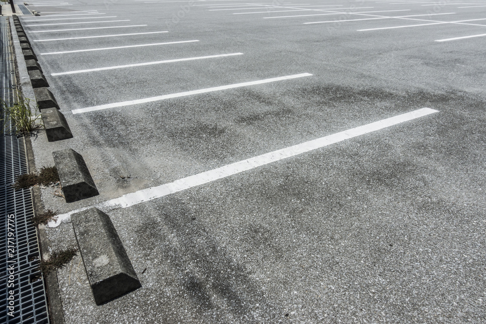 Fototapeta premium Empty parking lot with parking barrier, Vacant Parking Lot, Parking lane painting on floor, copy space