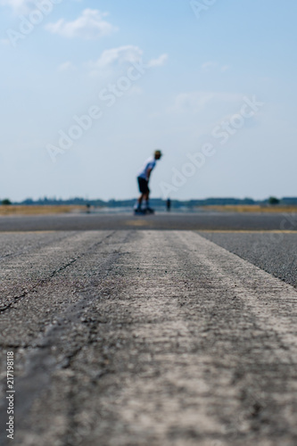 empty asphalt road   street with person on skateboard