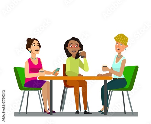 Three girls sitting at a table together talking to coffee break.