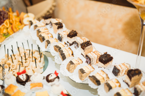 Delicious sweets on wedding candy buffet with desserts, cupcakes