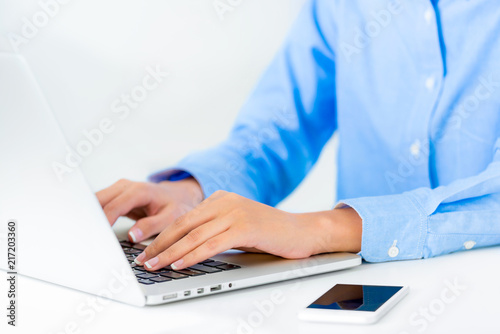 Businesswoman hands typing and smart phone laptop keyboard on desk office in the workspace  Woman worker  Business and finance concepts.