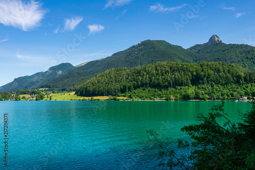 Lake called Wolfgangsee in Austria with Mountains in the Background and Clouds on the Sky