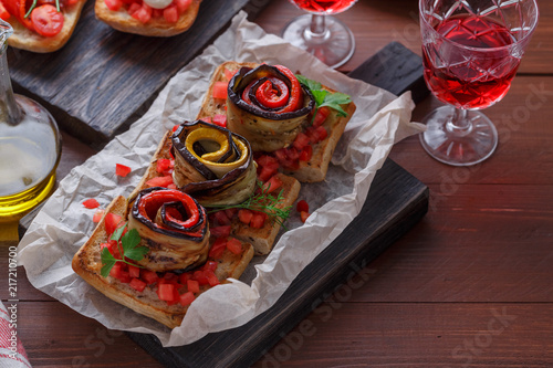 Bruschetta with tomato, basil and mozzarella cheese on wooden board. Traditional italian appetizer or snack, antipasto photo