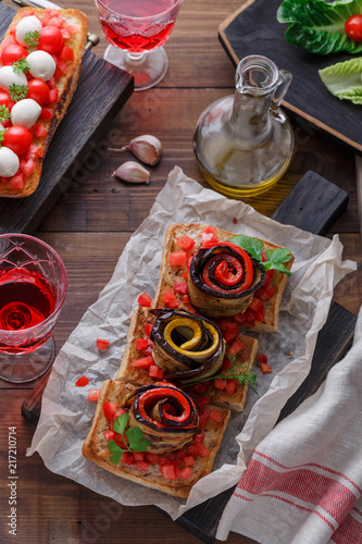 Bruschetta with tomato, basil and mozzarella cheese on wooden board. Traditional italian appetizer or snack, antipasto photo