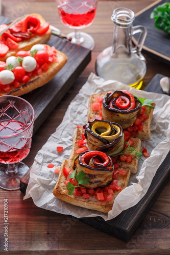 Bruschetta with tomato, basil and mozzarella cheese on wooden board. Traditional italian appetizer or snack, antipasto photo