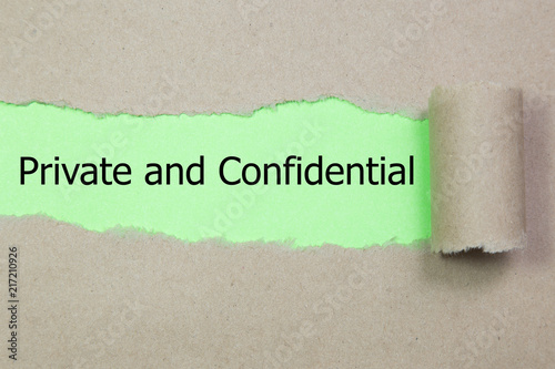 The word Private and confidential appearing behind torn paper.