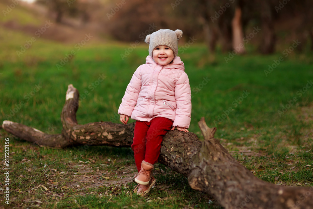 Portrait of beautiful happy child walking on autumn colorful leaves and grass background. Funny girl outdoors in fall park. Portrait of beautiful happy child walking on autumn colorful leaves and grass background. Funny girl outdoors in fall park.