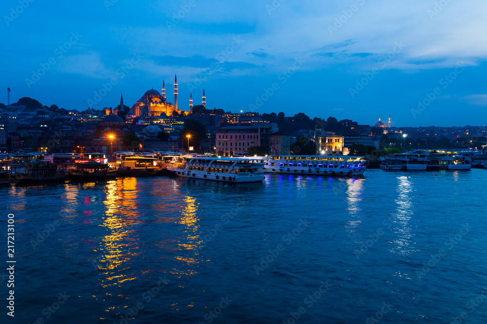 Night view of Istanbul. Panorama cityscape of famous tourist destination Golden Horn bay part of Bosphorus strait. Travel illuminated landscape Bosporus, Turkey, Europe and Asia.