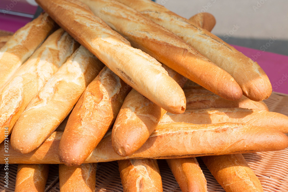 Baguettes, the famous long and thin french bread. Close up of a pile of baguettes