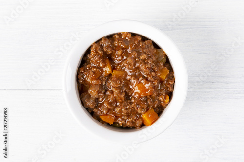 Bolognese sauce. In a white plate. The background is white. Italian food. Copy space. Top view. Horizontal shot.