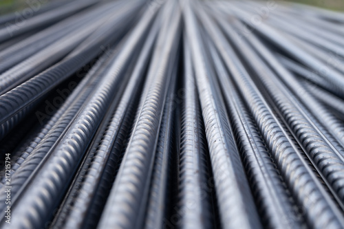 Stack of heavy metal reinforcement bars with periodic profile texture. Close up steel construction armature. Abstract industrial background concept. Copy space. photo