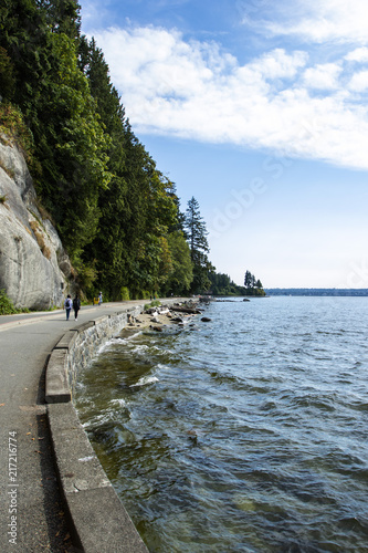 touristis on stanley park seawall on a sunny summer day photo