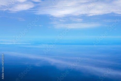 Aerial view with cloud ripples above the ocean and fluffy cloudscape © ApiFoto
