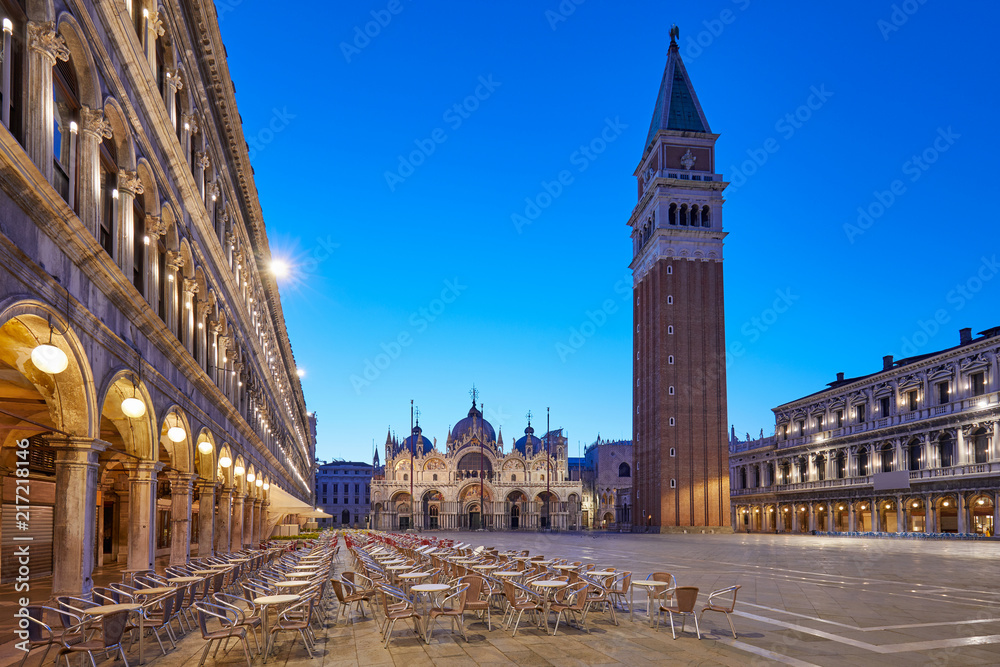 San Marco square illuminated in the early morning, empty tables and chairs in Italy
