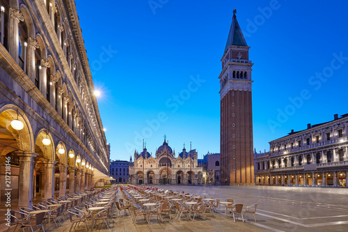 San Marco square illuminated in the early morning, empty tables and chairs in Italy