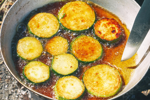 Fried zucchini in a frying pan.