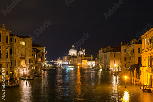 Night view of grand canal in Venice surrounded by Venetian Gothic architectures and Basilica di Santa Maria della Salute is the landmark. © Peeradontax