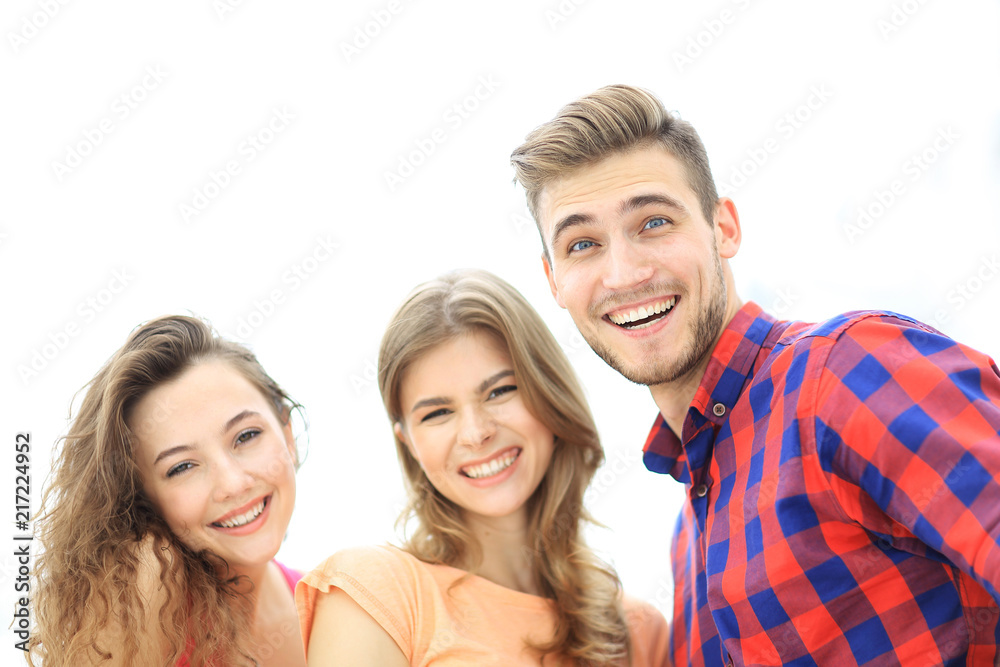 closeup of three young people smiling on white background closeup of three young people smiling on white background