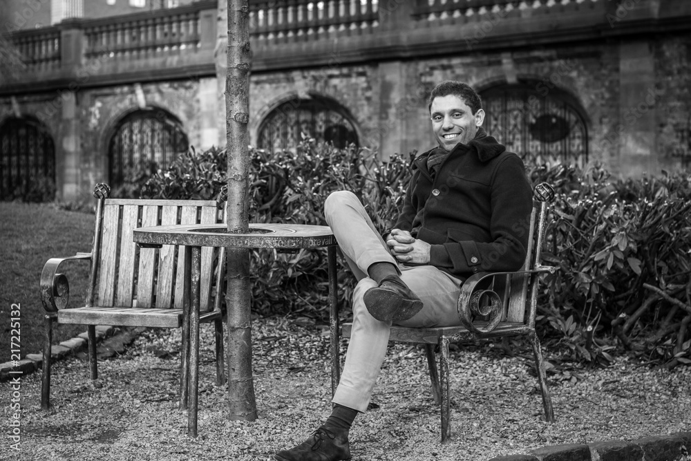 Man sitting on a chair in a park Man sitting on a chair in a park