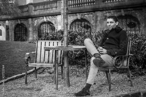Photography Man sitting on a chair in a park
