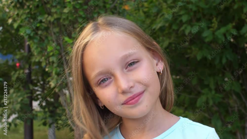Adorable girl touching blonde hair and looking at camera, reversed Adorable girl touching blonde hair and looking at camera, reversed