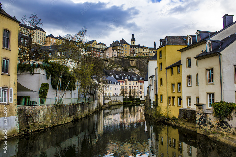 Traditional European Buildings in the Village of Grund Reflecting on the Water of the Alzette River in Luxembourg City, Luxembourg