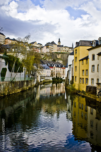 Fototapeta Naklejka Na Ścianę i Meble -  View down the Alzette River with the Beautiful Traditional Buildings of the Village of Grund in Luxembourg City, Luxembourg
