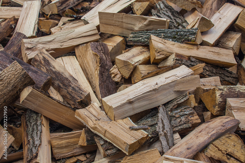 Woodpile of chopped lumber. Pile of wood logs. Stacked firewood timber Woodpile of chopped lumber. Pile of wood logs. Stacked firewood timber