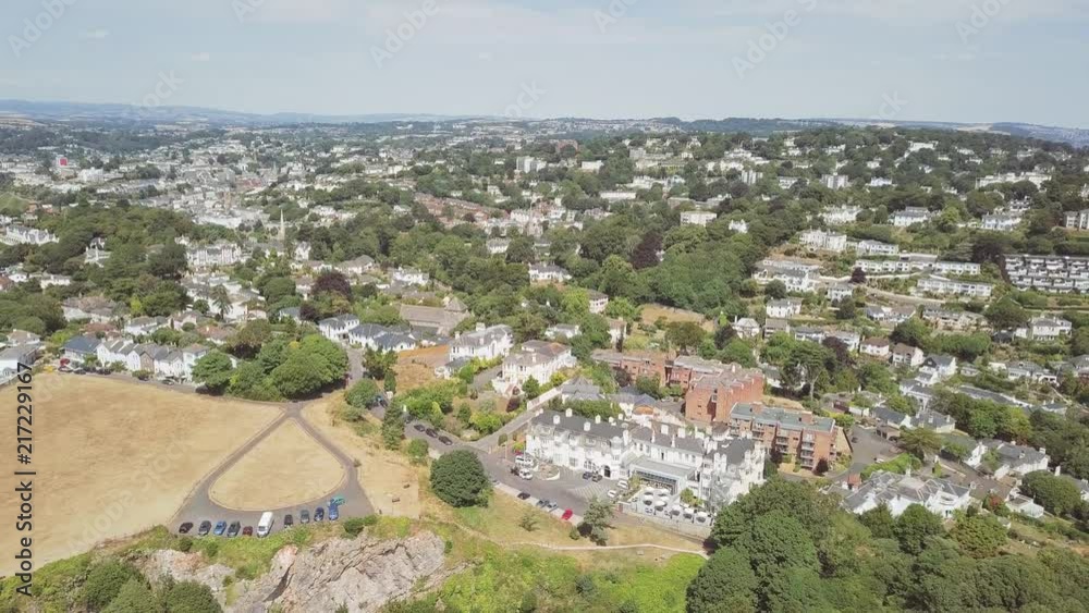 Aerial view of coastal town Torquay in southwest England. A lot of homes, resorts, and hotels are visible in this dense location. The sky is clear. Aerial view of coastal town Torquay in southwest England. A lot of homes, resorts, and hotels are visible in this dense location. The sky is clear.