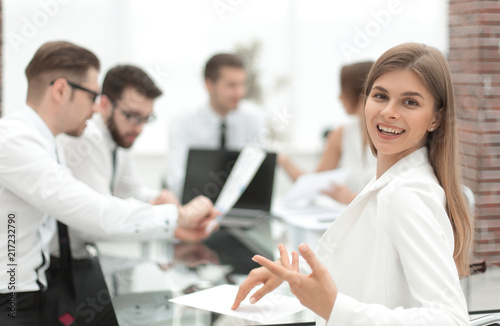 young employee sitting at his Desk and looking at the camera