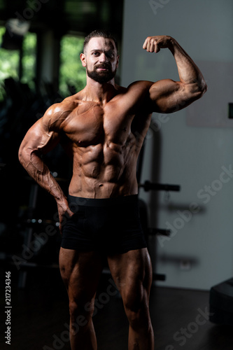 Biceps Pose Of A Young Man In Gym © Jale Ibrak