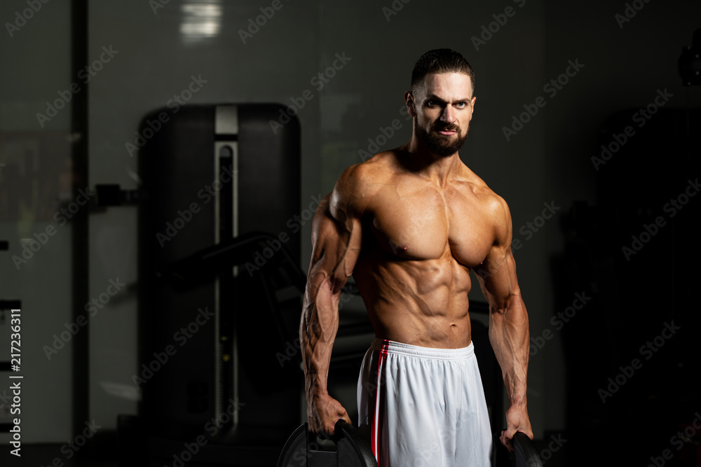 Fit Man Holding Weights In Hand