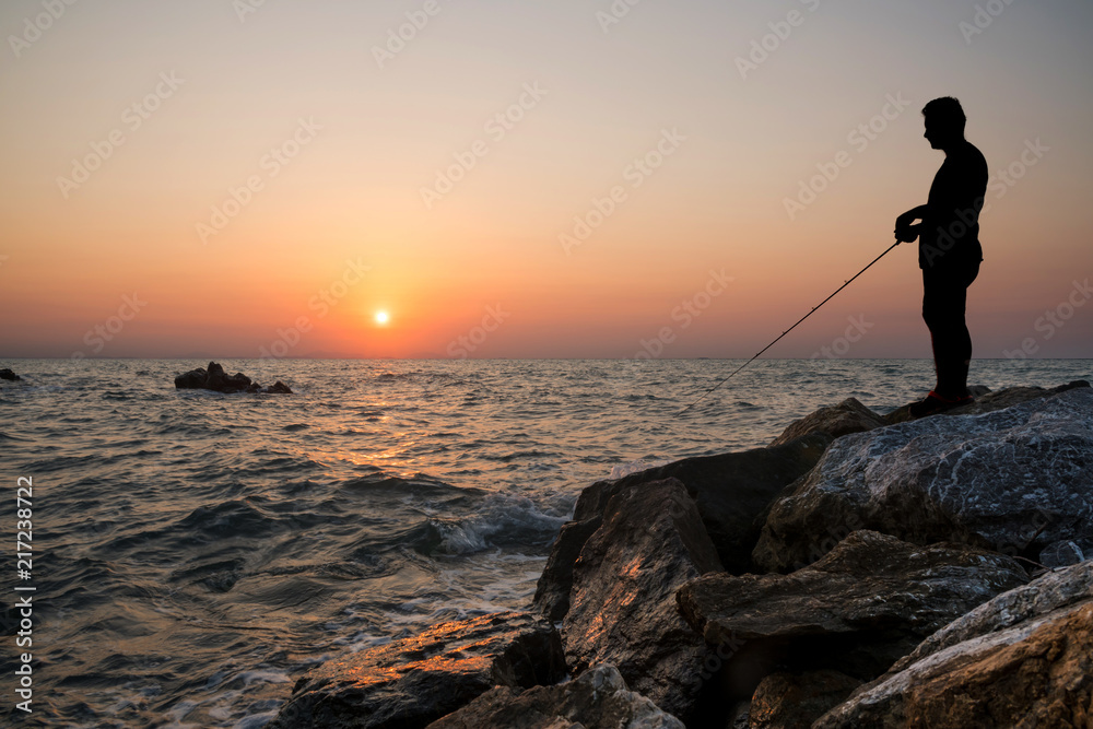 Man fishing on sunset