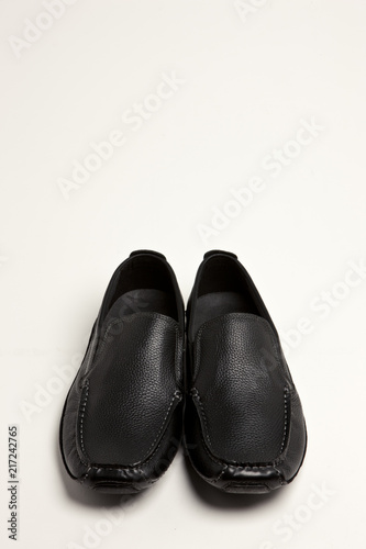 black leather shoes on the white background.