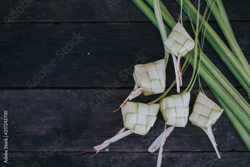 Ketupat (rice dumpling) on vintage wood background.Famous traditional food during celebration of Eid Ul Fitr and Eid ul Adh.