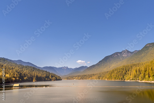 lake among the mountains covered with dense forests, a building on the lake © Viktor Birkus