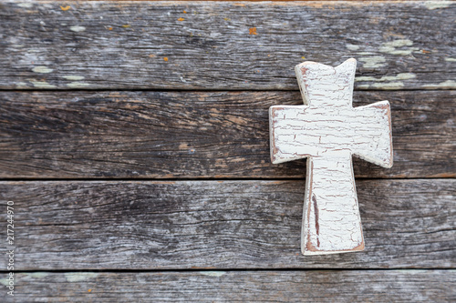 White cross on weathered barn wood background