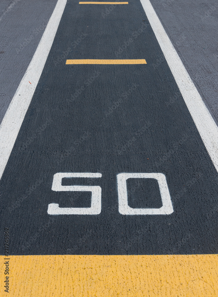 Runway of airport guideline, take off and 50 percent sign printed on the asphalt Takeoff runway and runway aircraft carrier on battleship. Public area.