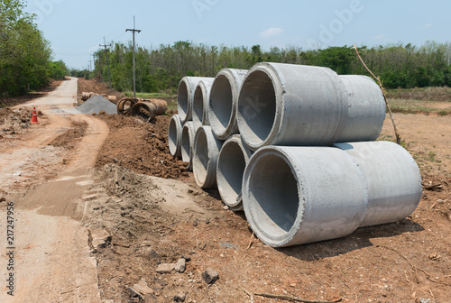 Wallpaper Mural Pile of Concrete Drainage Pipe  aligned on a Construction Site .Concrete pipe stacked sewage water system on site. Torontodigital.ca