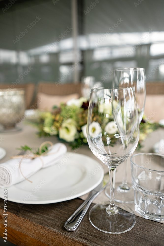 Wedding Banquet or gala dinner. The chairs and table for guests, served with cutlery and crockery. Covered with a linen tablecloth runner. party on terrace Wedding Banquet or gala dinner. The chairs and table for guests, served with cutlery and crockery. Covered with a linen tablecloth runner. party on terrace
