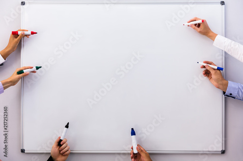 Businesspeople Writing On Blank White Board