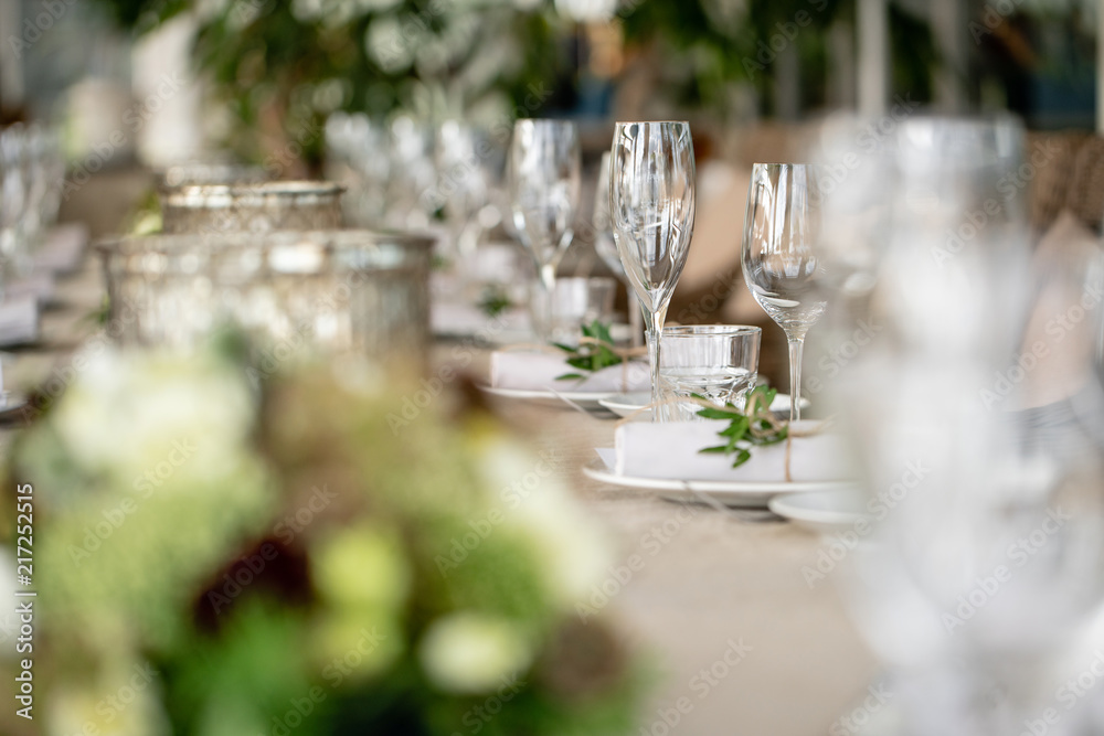 Wedding Banquet or gala dinner. The chairs and table for guests, served with cutlery and crockery. Covered with a linen tablecloth runner. party on terrace Wedding Banquet or gala dinner. The chairs and table for guests, served with cutlery and crockery. Covered with a linen tablecloth runner. party on terrace