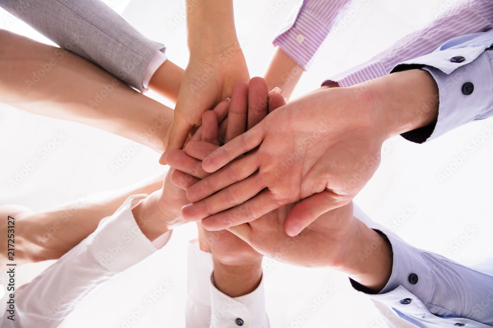 Close-up Of Businesspeople Stacking Hands Close-up Of Businesspeople Stacking Hands