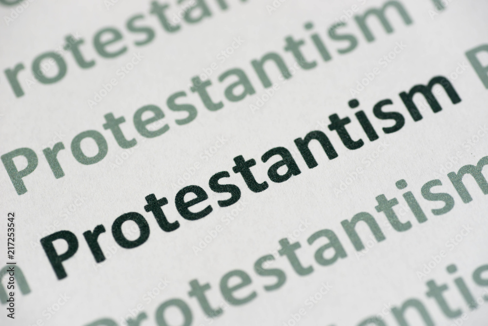 Fototapeta premium word Protestantism printed on paper macro