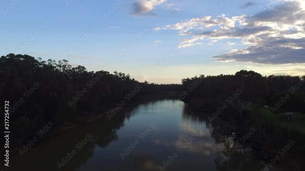 Drone ascending over The Murray River, New South Wales Australia, during sunset reveal blue sky with clouds. Drone ascending over The Murray River, New South Wales Australia, during sunset reveal blue sky with clouds.