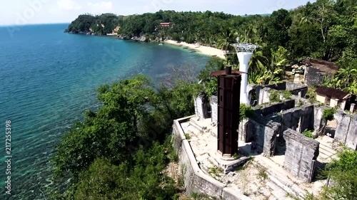 Aerial drone video of an old 18th century spanish colonial lighthouse built beside the beach in Guimaras in the Philippines, Southeast Asia. Guisi lighthouse is second to the oldest watch tower. photo